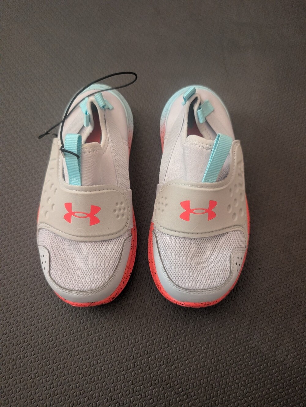 Under Armour Kids Slip-On Sneakers in White with Coral and Light Blue Accents